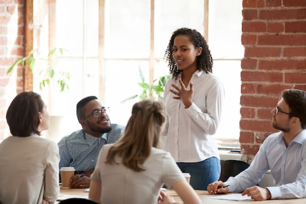 women talking in front of colleagues