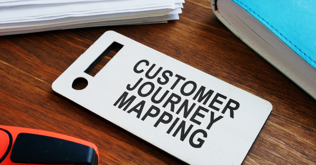 Customer journey mapping label on table with books around it